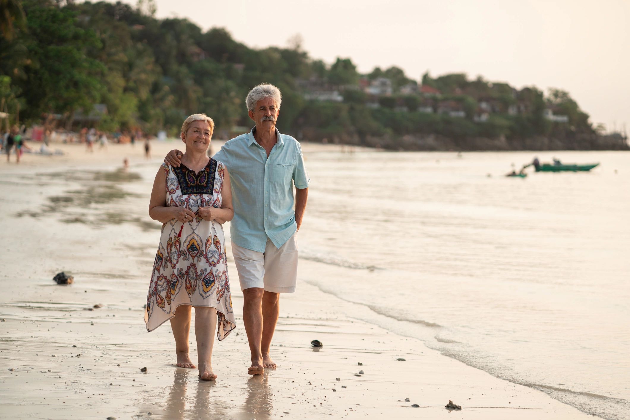 Senior couple taking a leisurely walk along the beach
