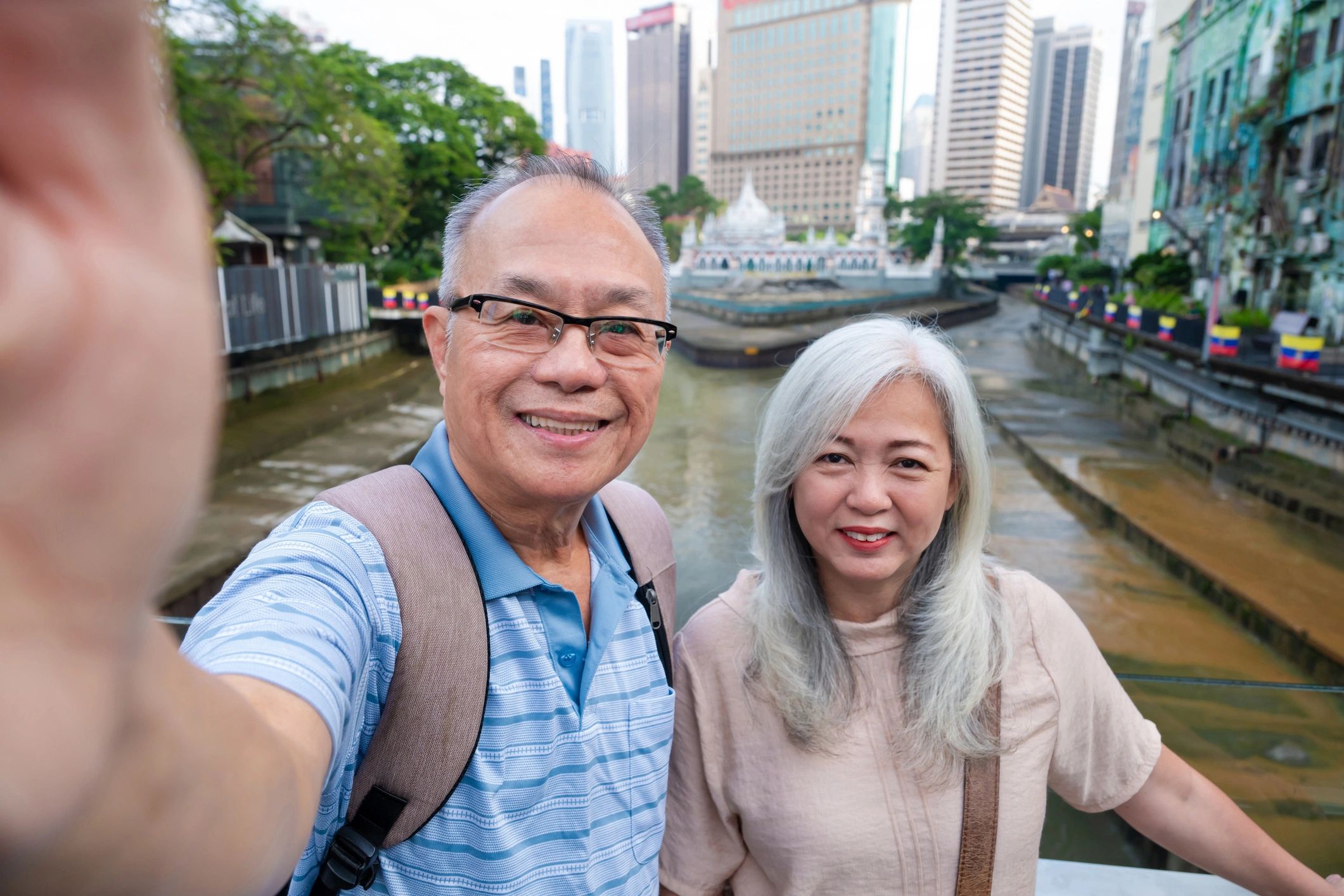 Senior travelers taking a selfie in a city destination