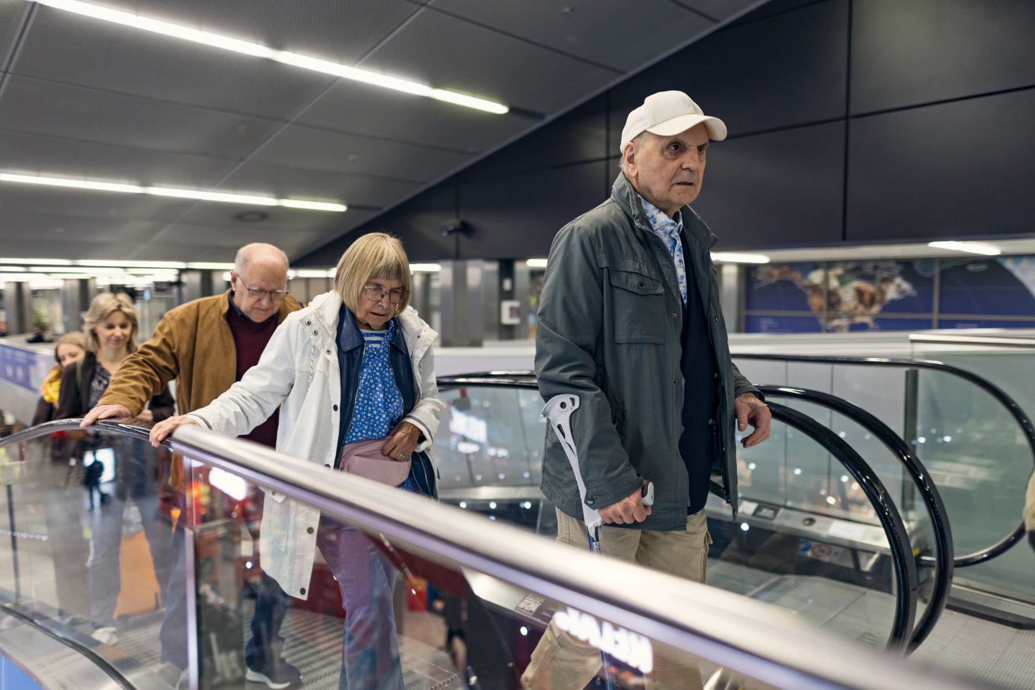 Senior travelers navigating an airport with mobility support