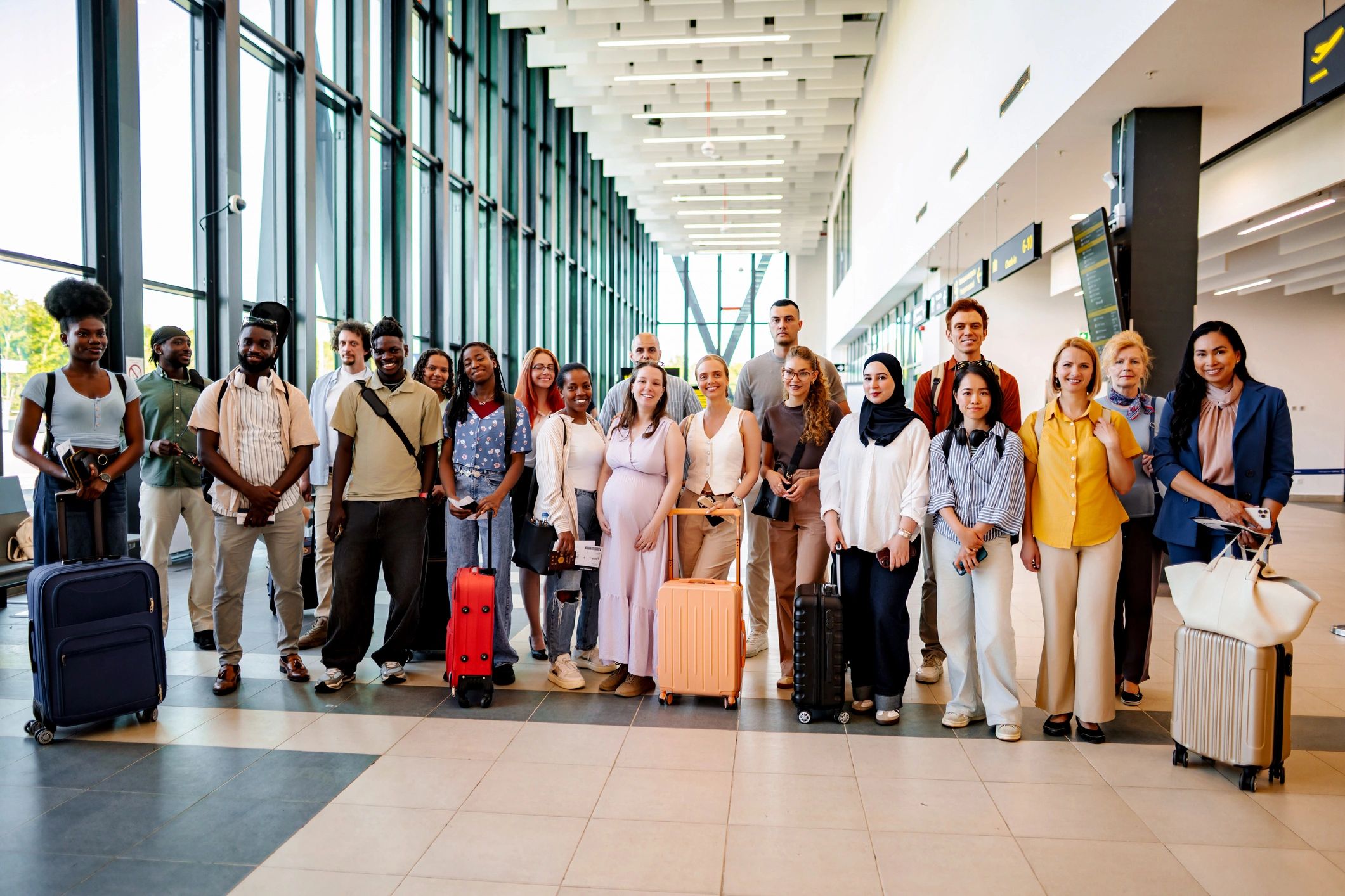 Diverse group of people traveling through modern airport
